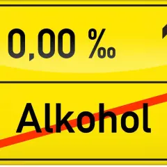 Żółty znak drogowy z napisem "0,00 % Alkohol" i przekreśleniem.